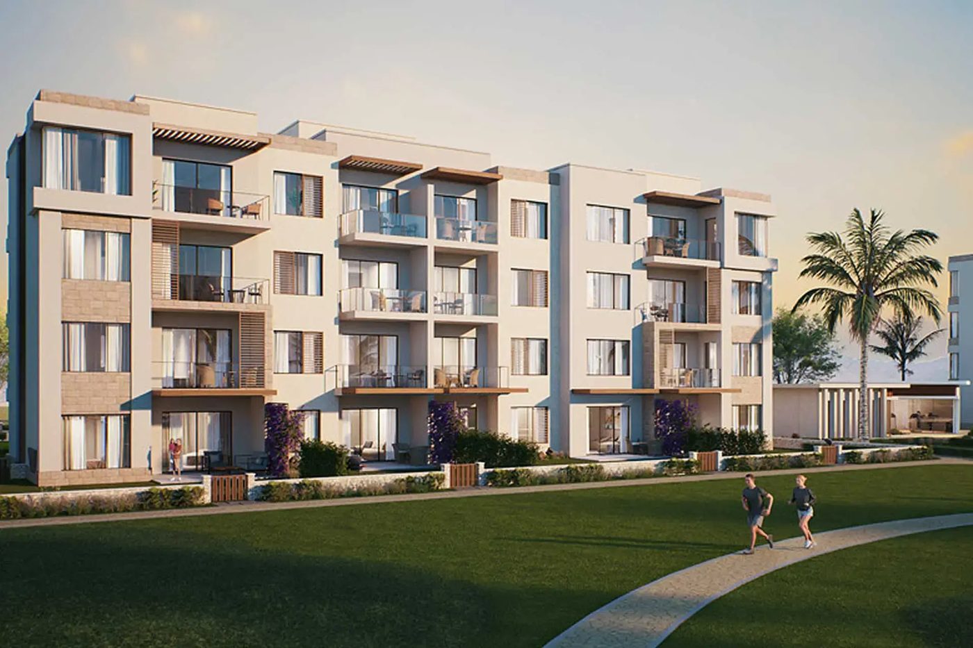 Solaris Jebel Sifah — building and lawn with a walking path at sunset