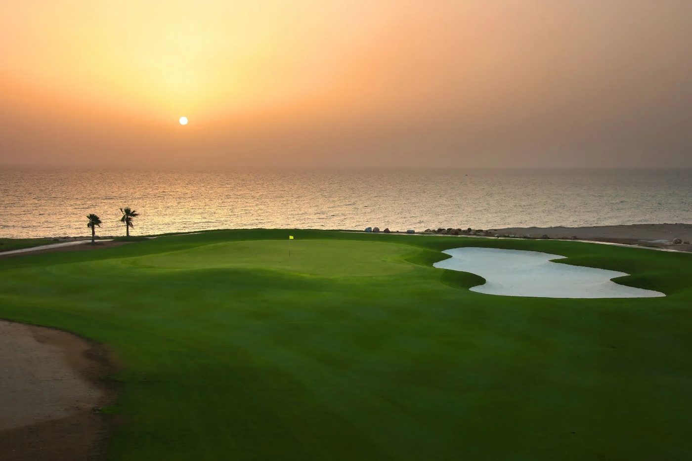 Jebel Sifah — golf course and the sea at sunset