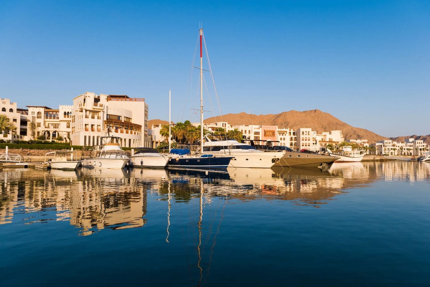 Jebel Sifah — yachts in the marina at golden hour